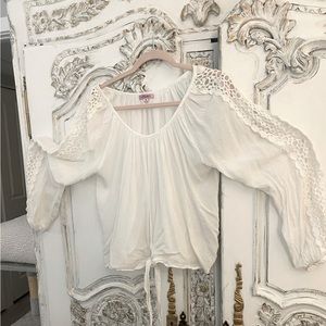 White cotton blouse with lace openings on sleeves